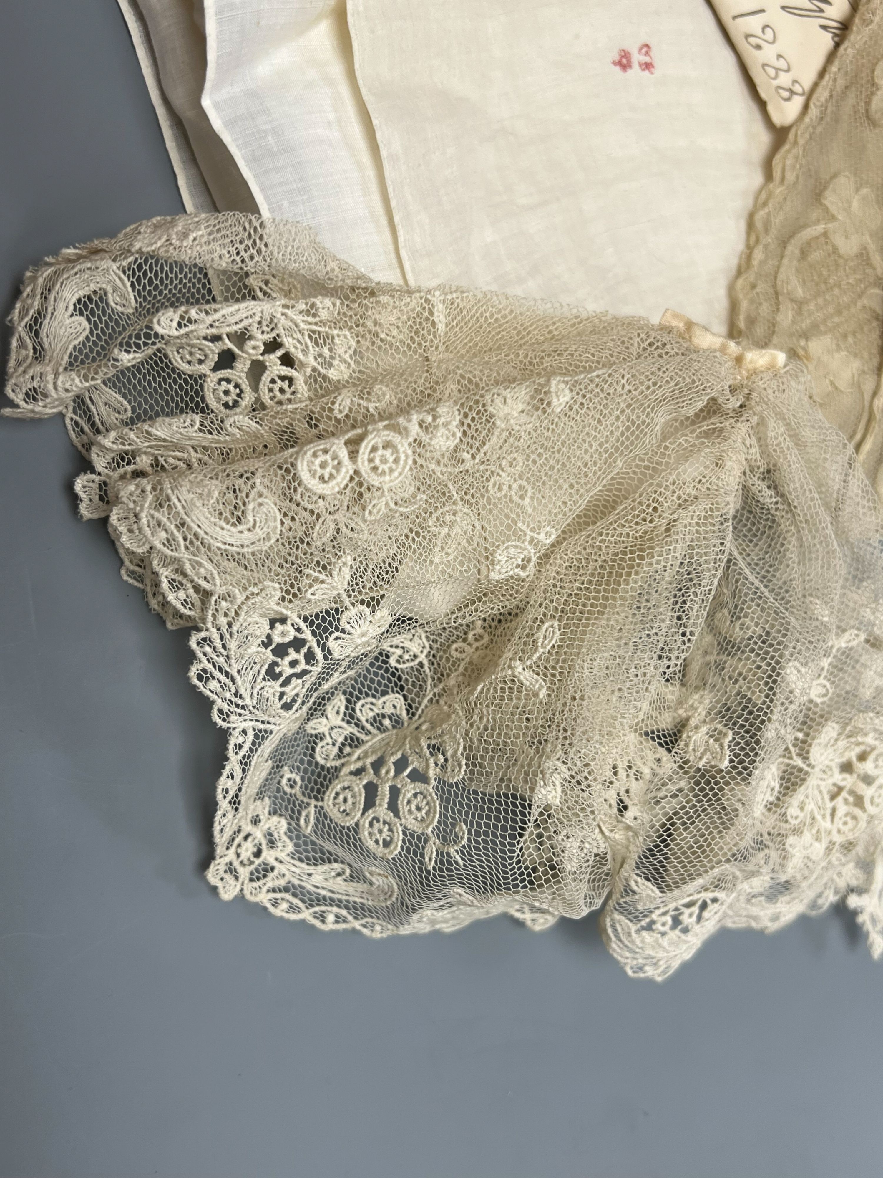 A George III handkerchief with George III cypher and three pieces of lace (4)